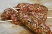 Three pieces of Lamb Kofta Kebab, skewered on wooden sticks, showing chunks of seasoned meat.