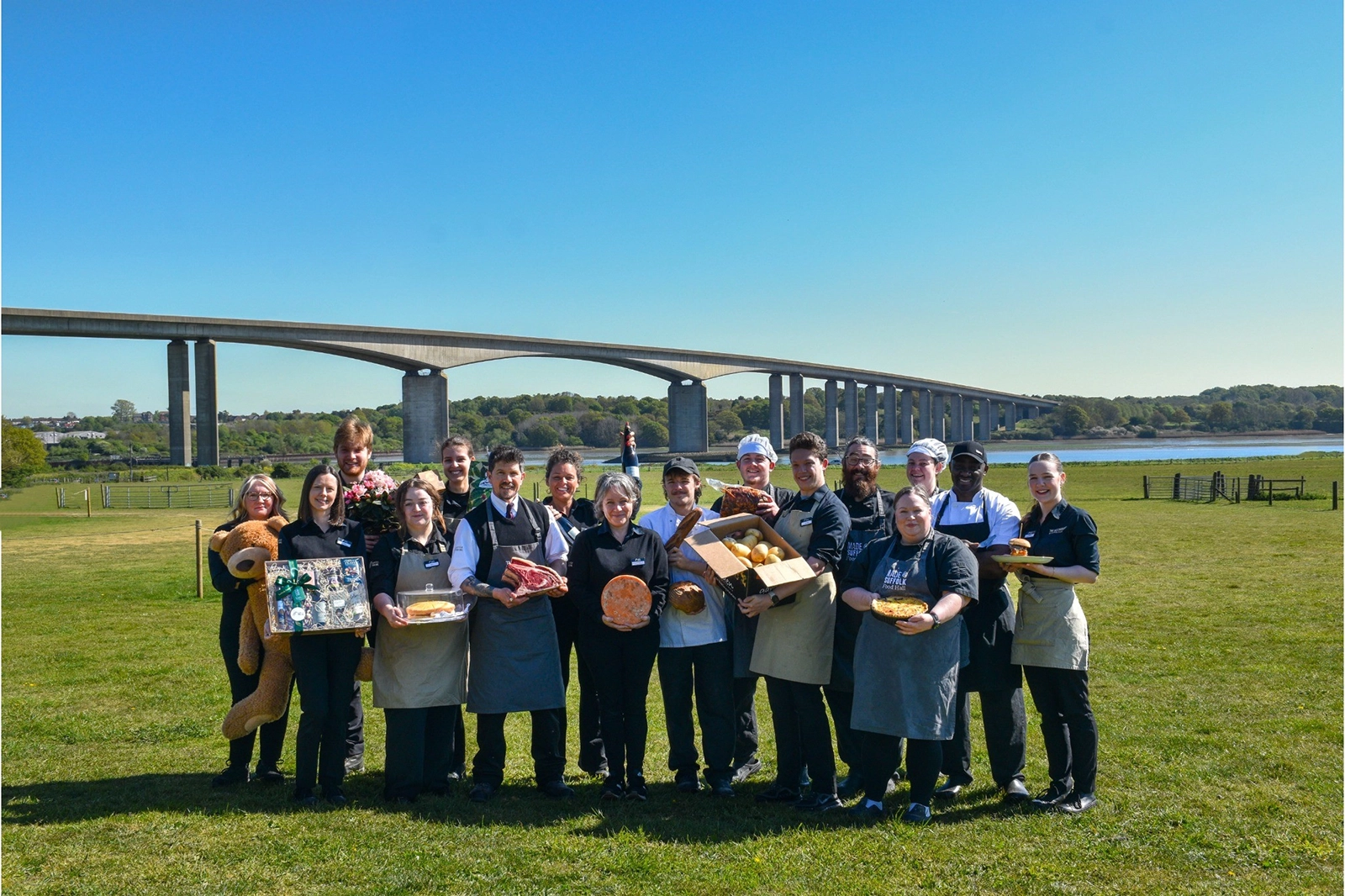 The Suffolk Food Hall team in front of the Orwell Bridge
